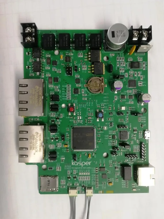 Green controller PCB with multiple communication connectors and a coin cell.