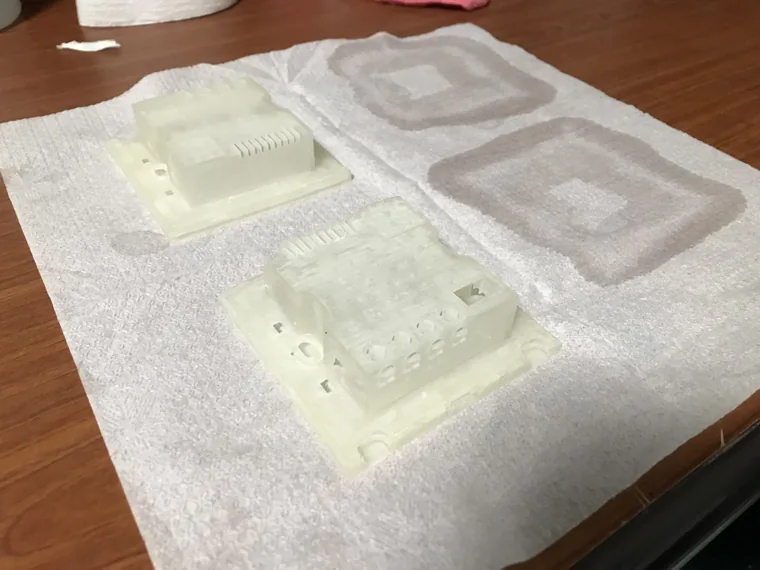 Translucent 3D-printed enclosure shells and frames arranged on a work surface.