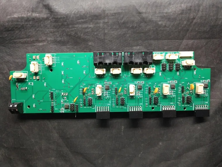 Wide green PCB populated with relays and connectors.
