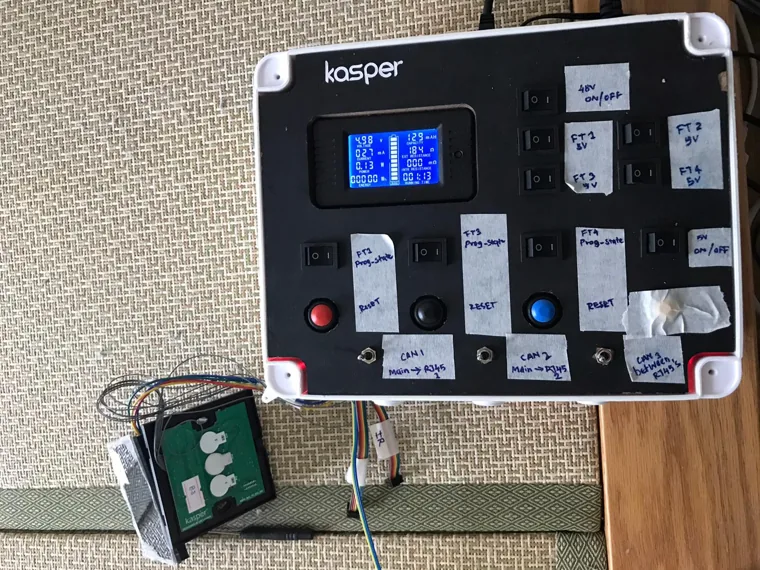 Kasper test jig in a carrying case connected to a small circuit board.